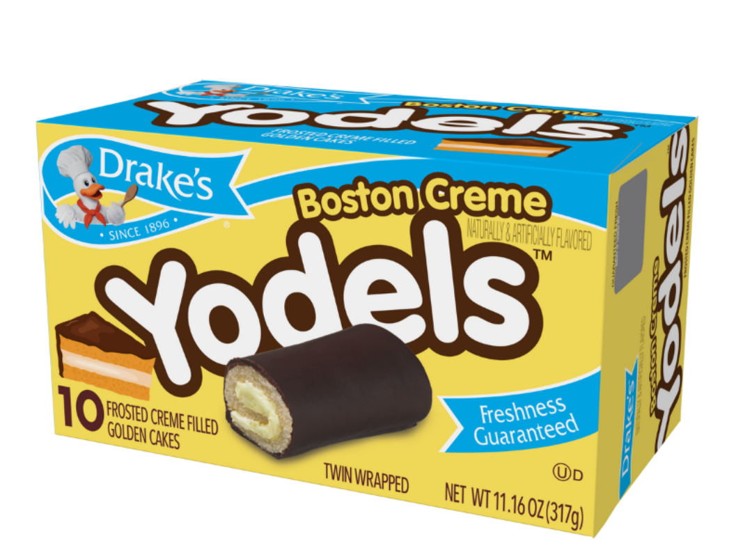 A yellow box of Drake’s Boston Creme Yodels featuring 10 chocolate-covered, creme-filled golden cakes.