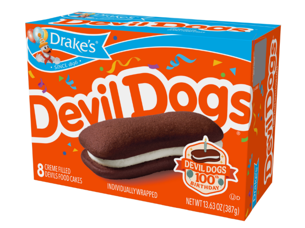 A box of Drake's Devil Dogs creme-filled cakes featuring an orange background and a picture of a cake in the center.