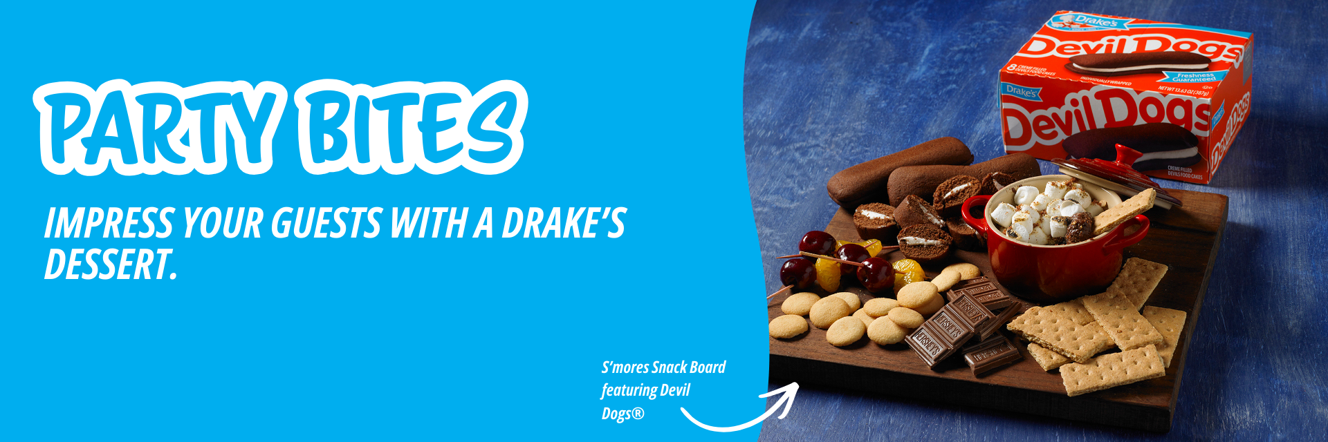 A promotional banner for Drake's Devil Dogs, featuring a wooden snack board with treats and crackers on a blue background.