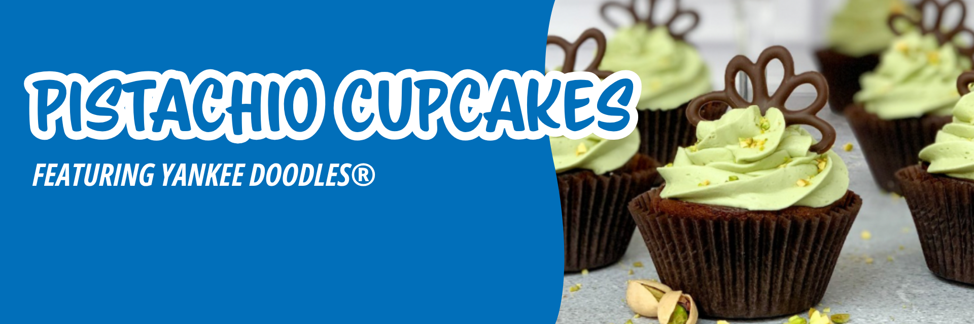 Close-up of pistachio-frosted cupcakes made with Drake's Cakes Yankee Doodles, sitting on a gray surface with a bright blue background.