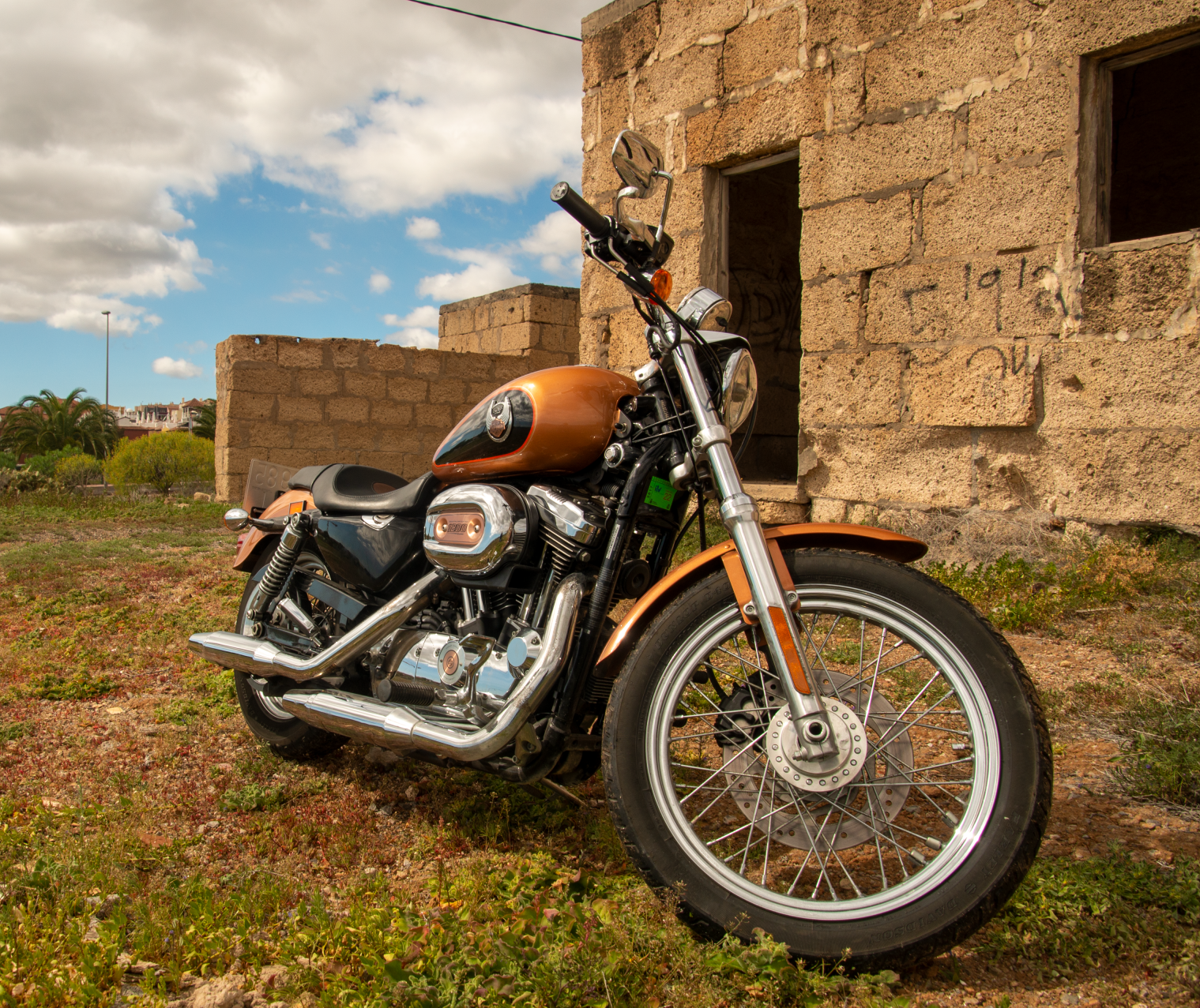 A motorcycle is parked in front of a stone building