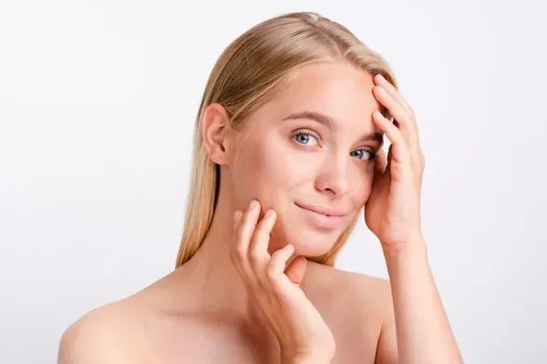 A woman with luminous, rejuvenated skin and a confident smile, showcasing the successful results of personalized skincare and professional aesthetic treatments.