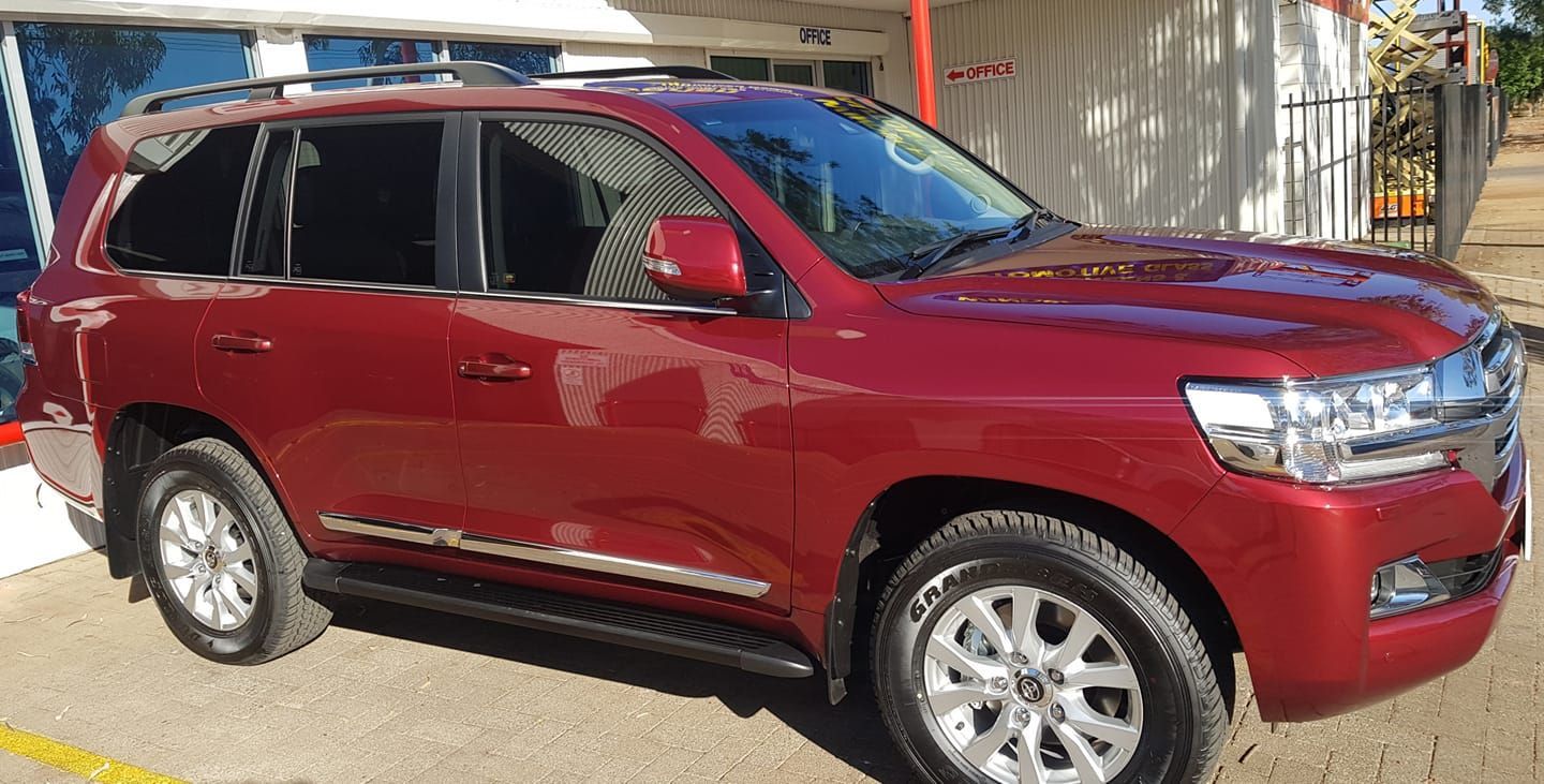 A red toyota land cruiser is parked in a parking lot — Glazier in Alice Springs, NT