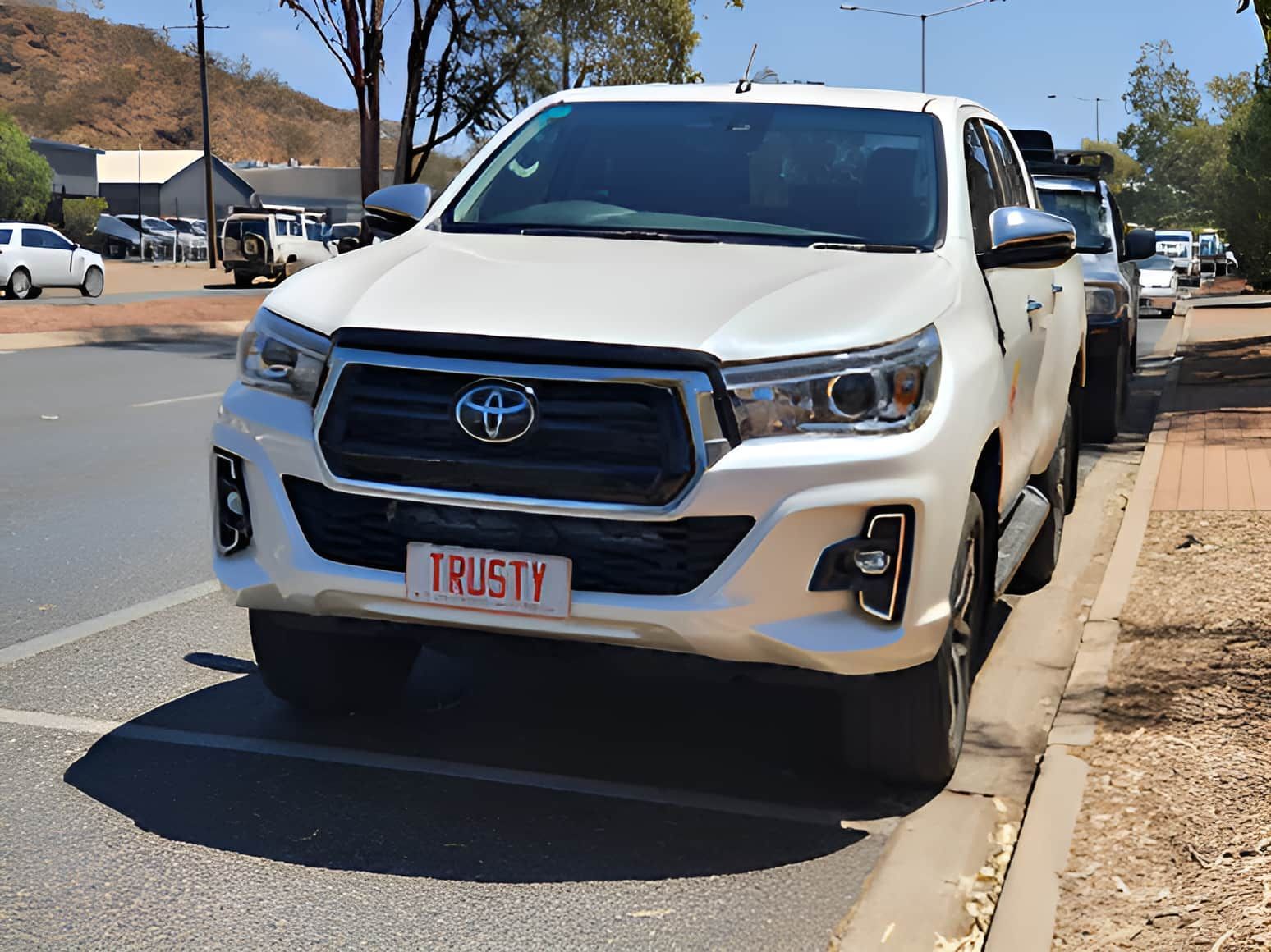 A White Truck With a License Plate That Says Trusty — Trusty Glass In Alice Springs, NT