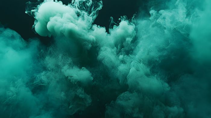 Emerald-green smoke billows and swirls against a dark background, creating a cloud-like effect.