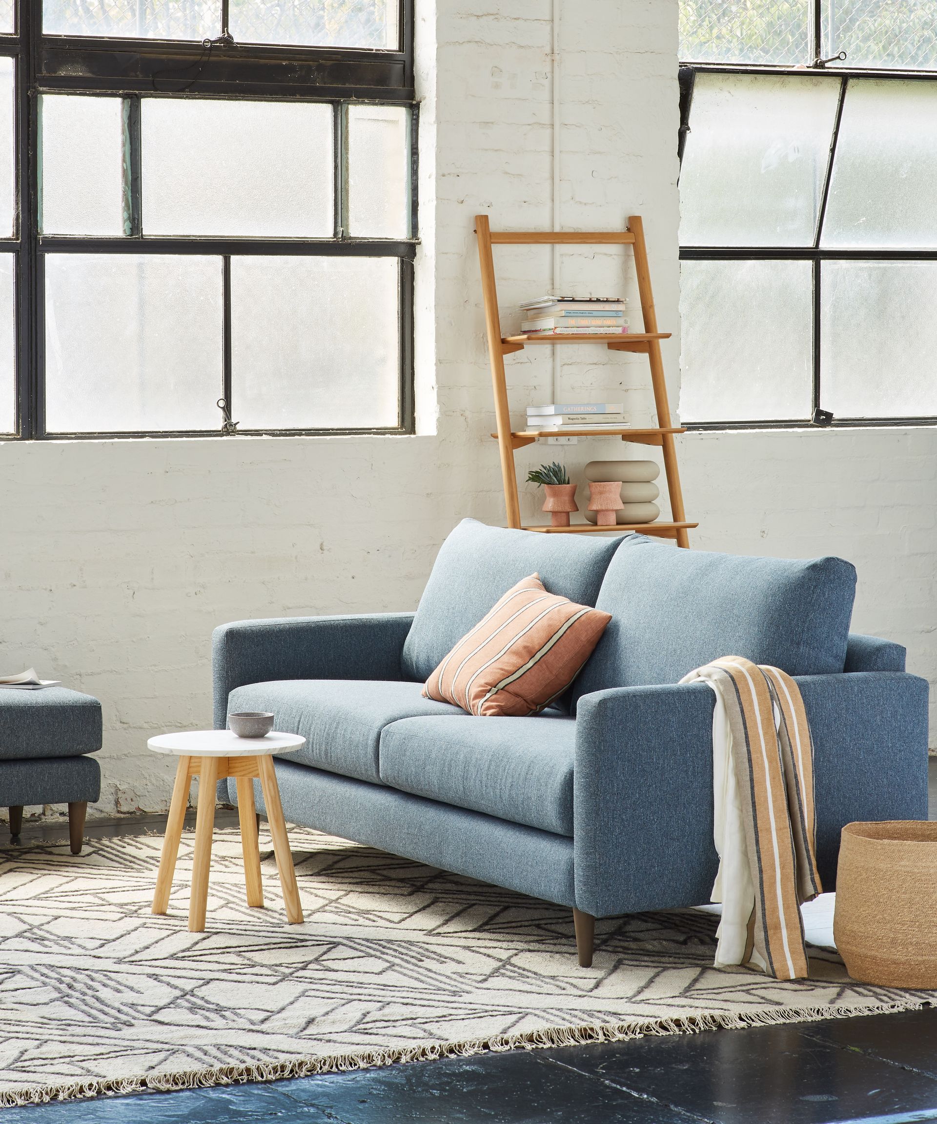 A Grey Couch With Pillows on a White Background — Envisage Furniture in Kialla, VIC