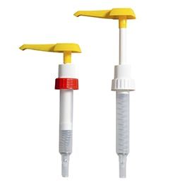 Two Bottle Pumps , One Yellow and One White , Are Sitting Next to Each Other on a White Background — Envisage Furniture in Kialla, VIC