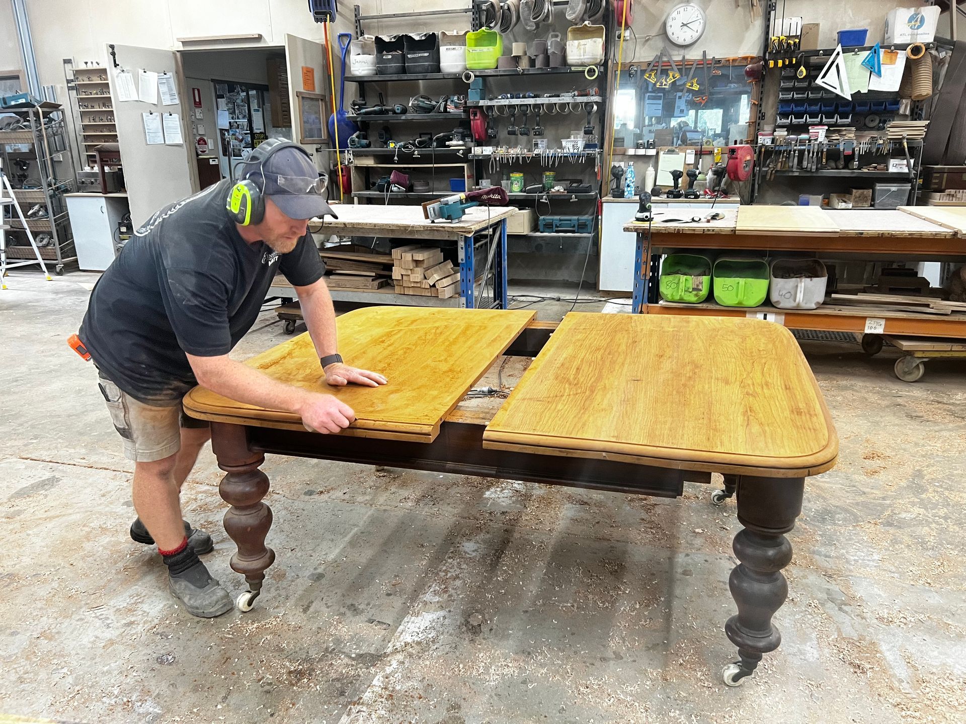 A Man is Working on a Wooden Table in a Workshop — Envisage Furniture in Kialla, VIC