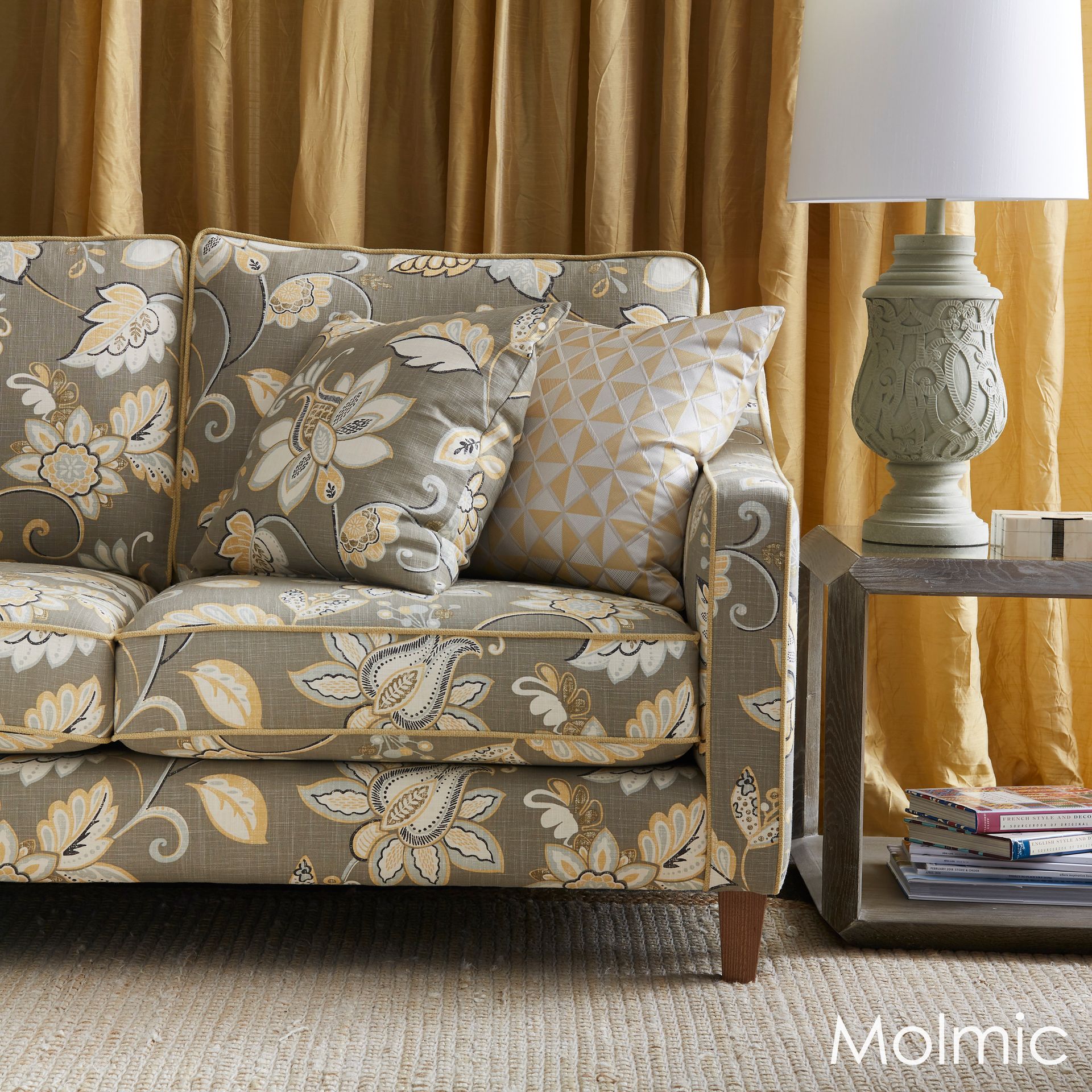 A couch with a floral pattern is next to a lamp — Envisage Furniture in Kialla, VIC