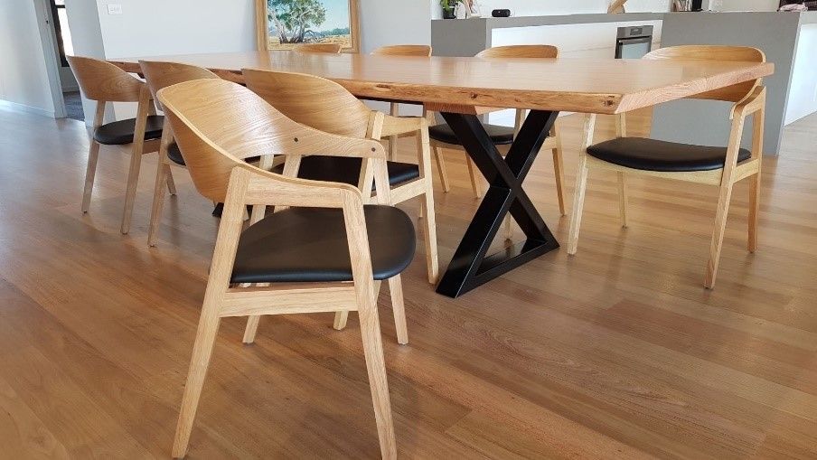 A Man is Standing Next to a Long Wooden Table in a Room โ Envisage Furniture in Kialla, VIC
