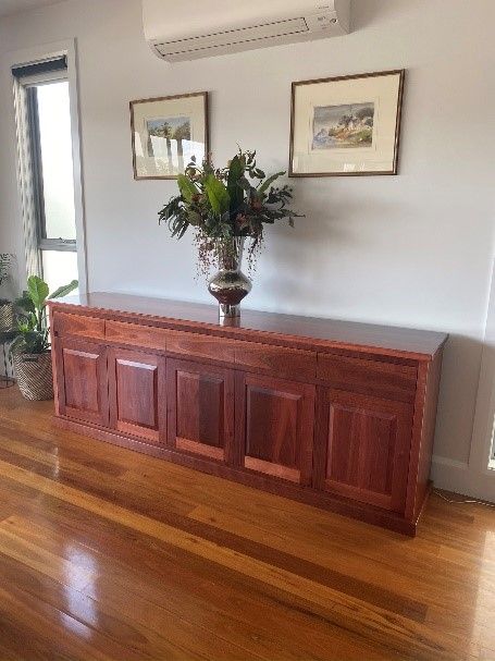 Timber sideboard with flowers in. vase— Envisage Furniture in Kialla, VIC