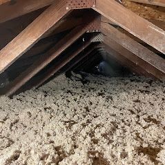 There is a lot of insulation in the attic of a house.