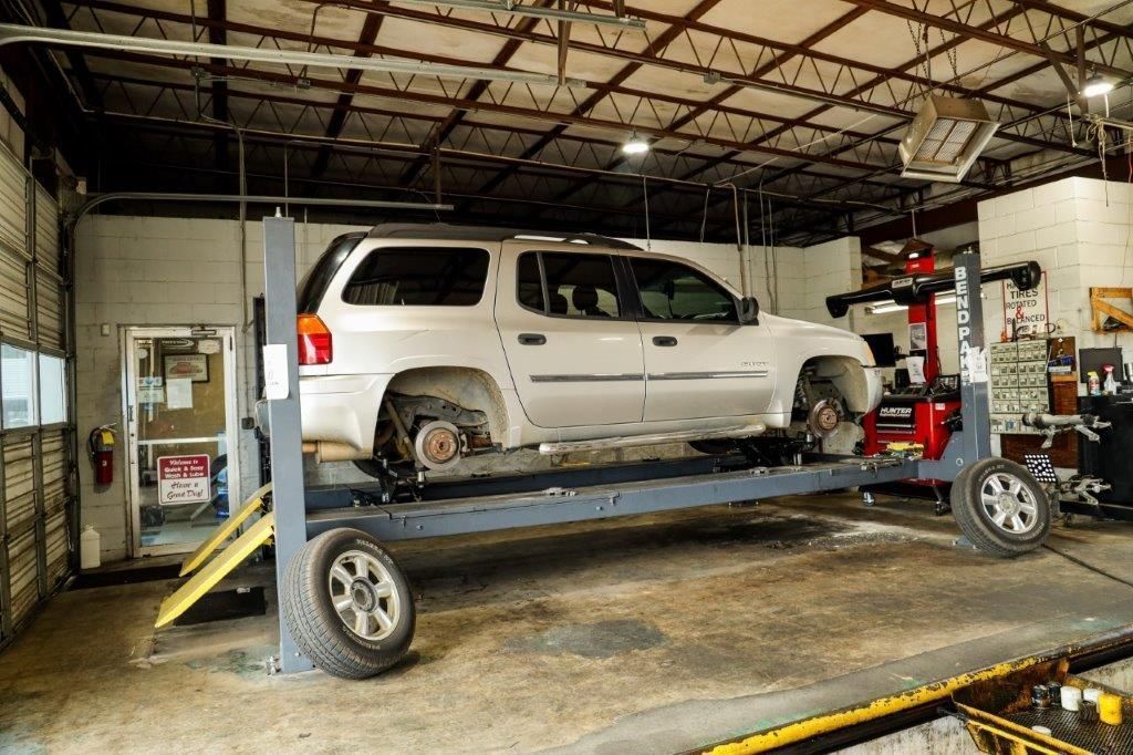 a car on a lift in a garage 