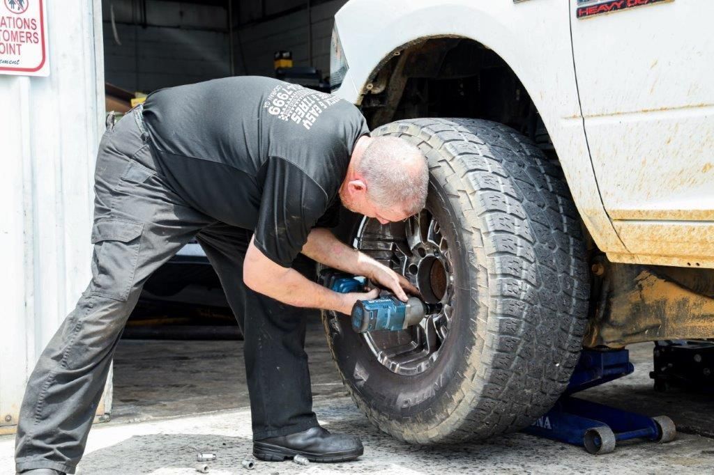 a heavy duty truck is being worked on by a man