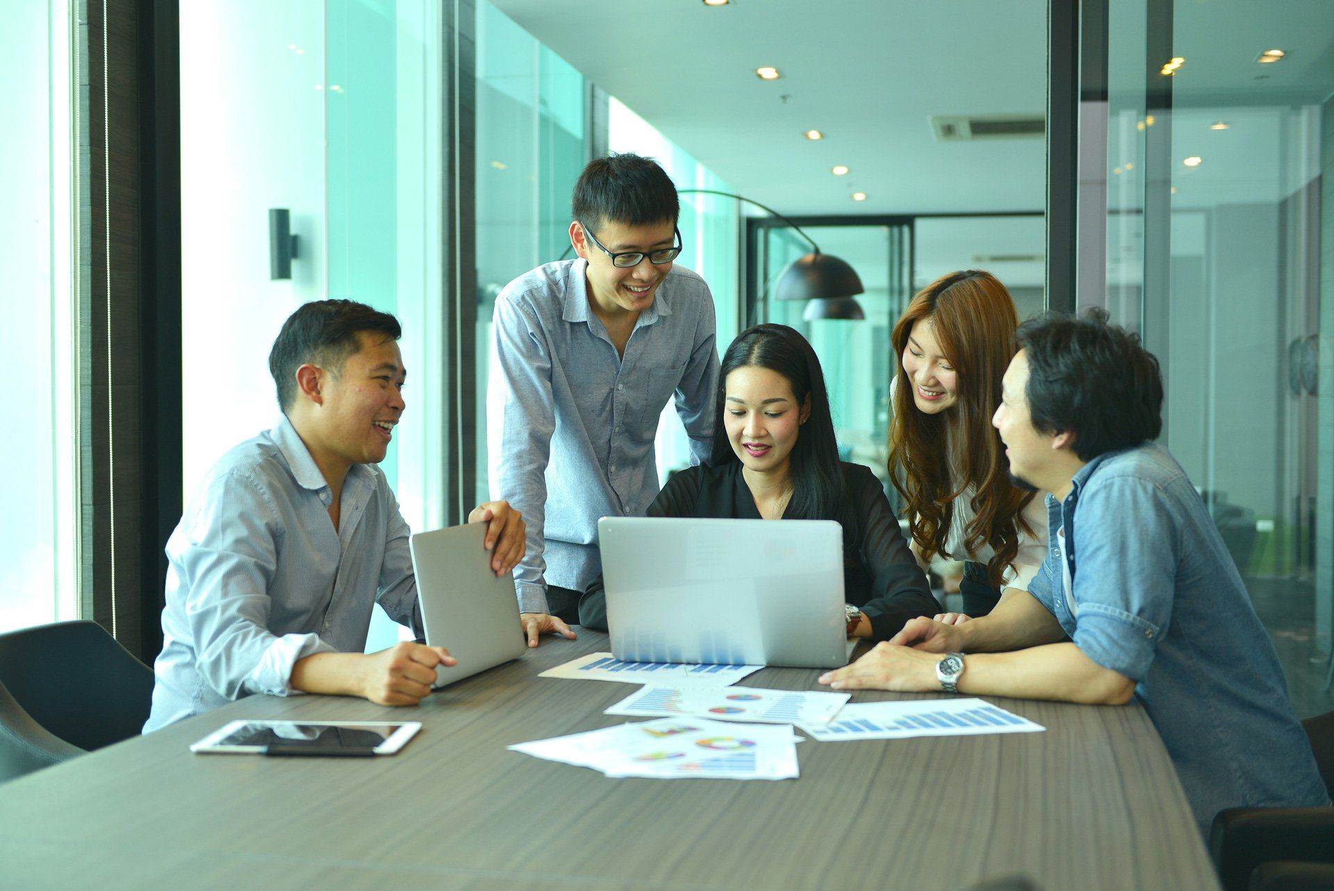 A group of people in an office talking to each other | Melbourne, VIC | Menzies Advisory