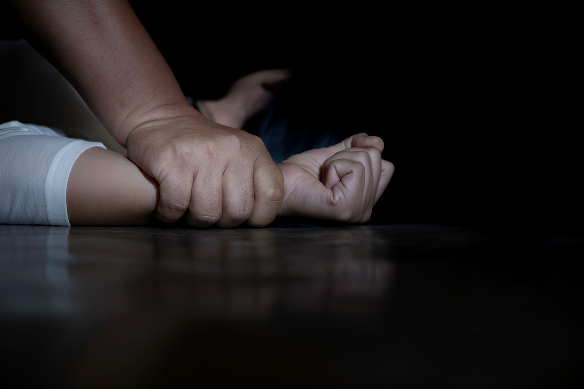 A Man Is Sexually Harassing A Girl In A Dark Room — Cairns Criminal Lawyers In Cairns City, QLD