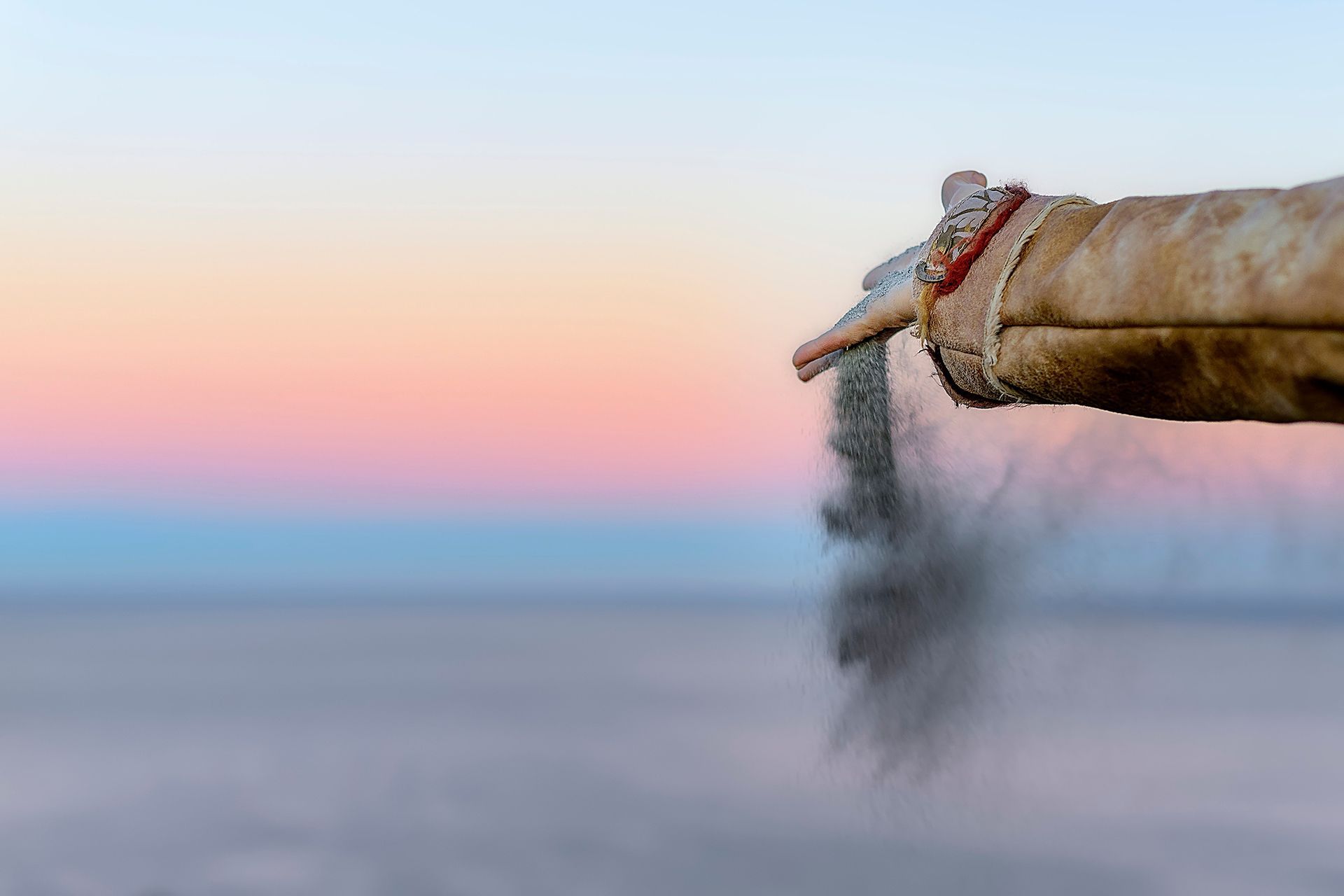A person is pouring ashes into a body of water.