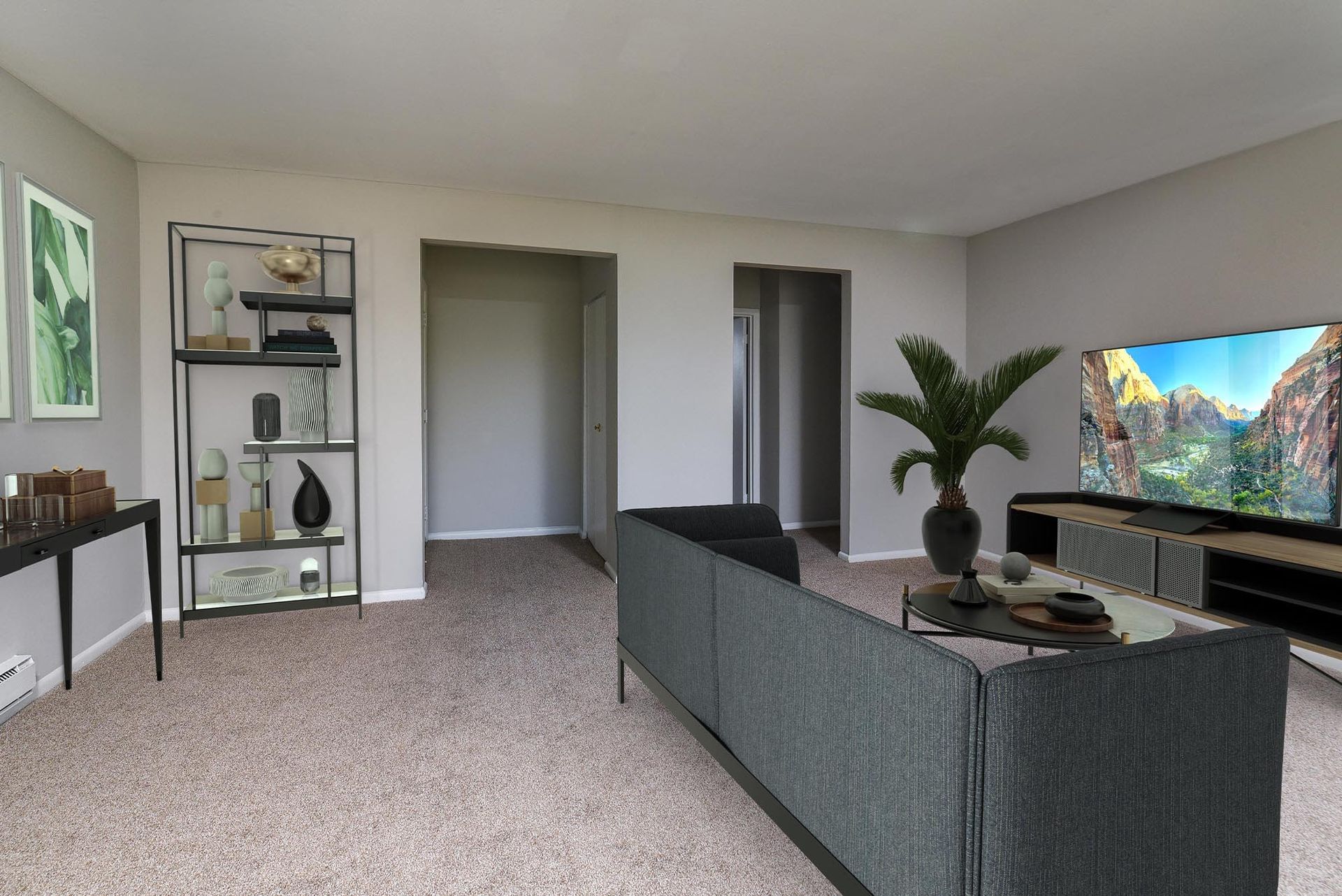 Living room in a modern apartment with a gray sectional sofa and large TV.