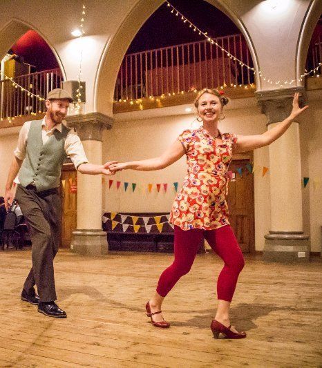 Two people swing dancing