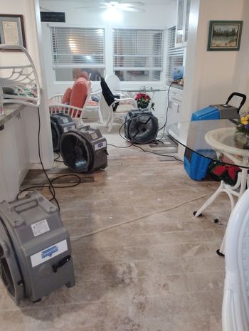 A living room filled with furniture and a vacuum cleaner.