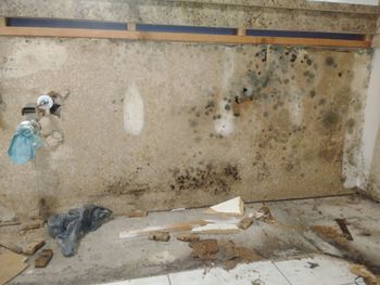 A dirty room with a dirty wall and a dirty floor