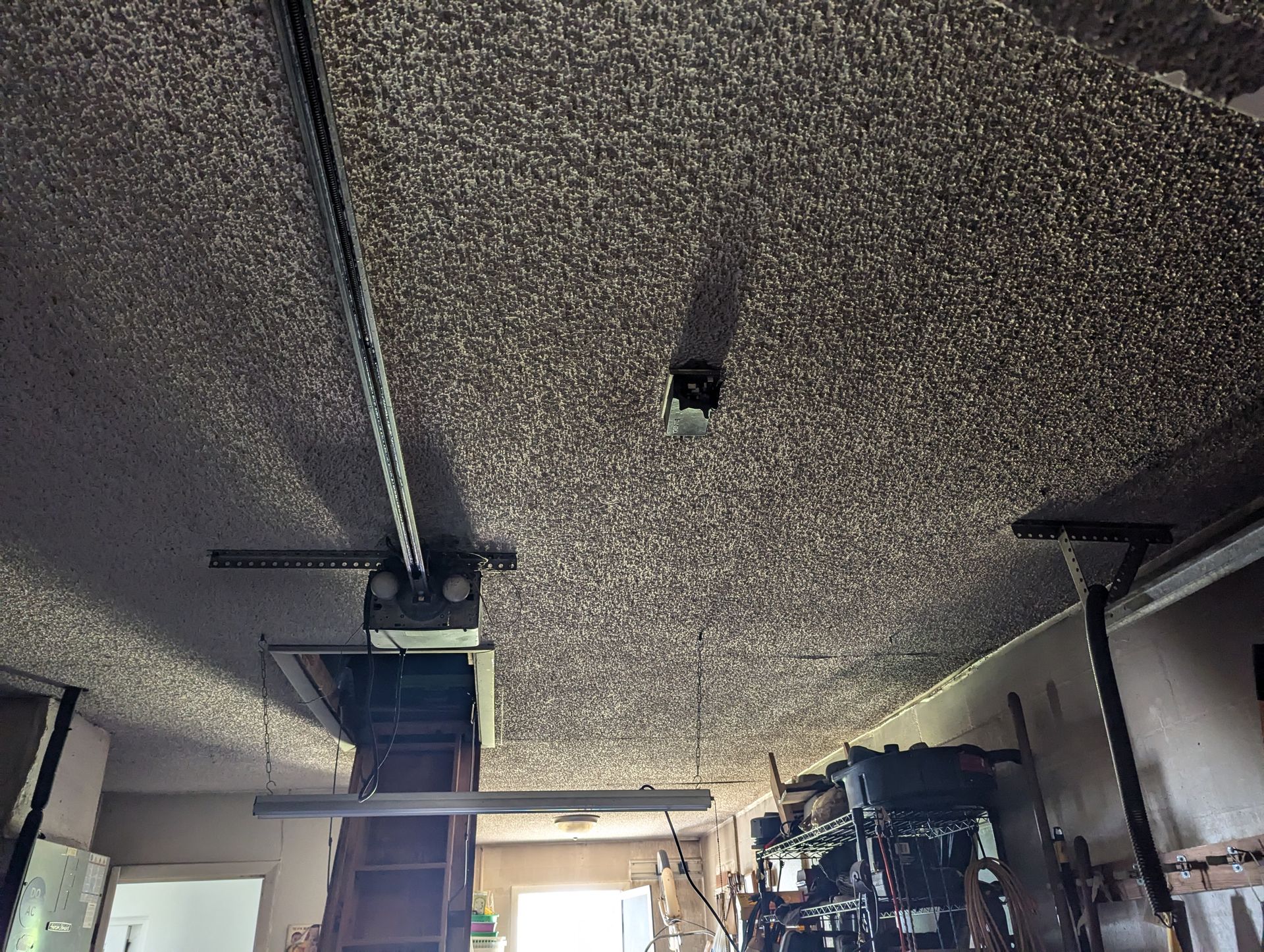 A garage with a ceiling that has a lot of dust on it.