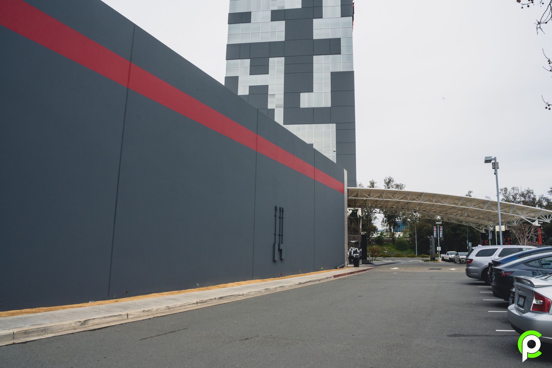 A parking lot with cars parked in front of a building