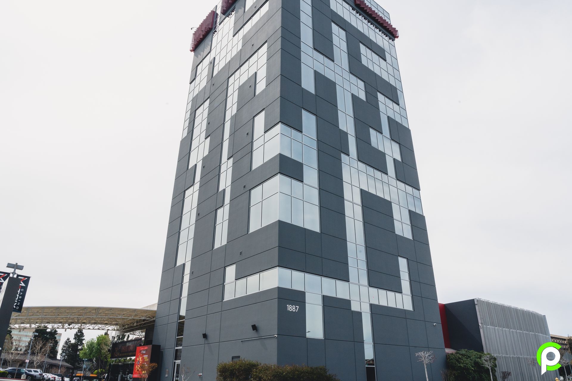 A tall building with a maze on the side of it