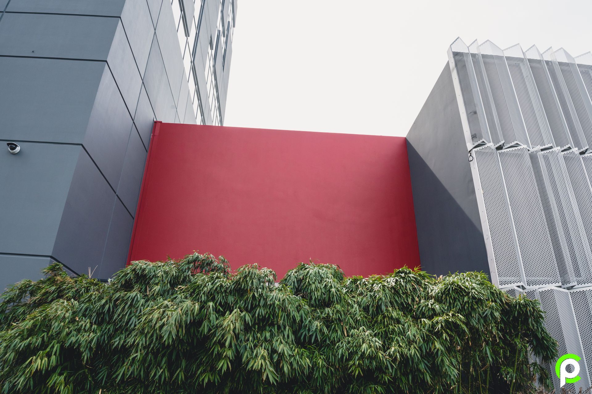 Looking up at a building with a red wall
