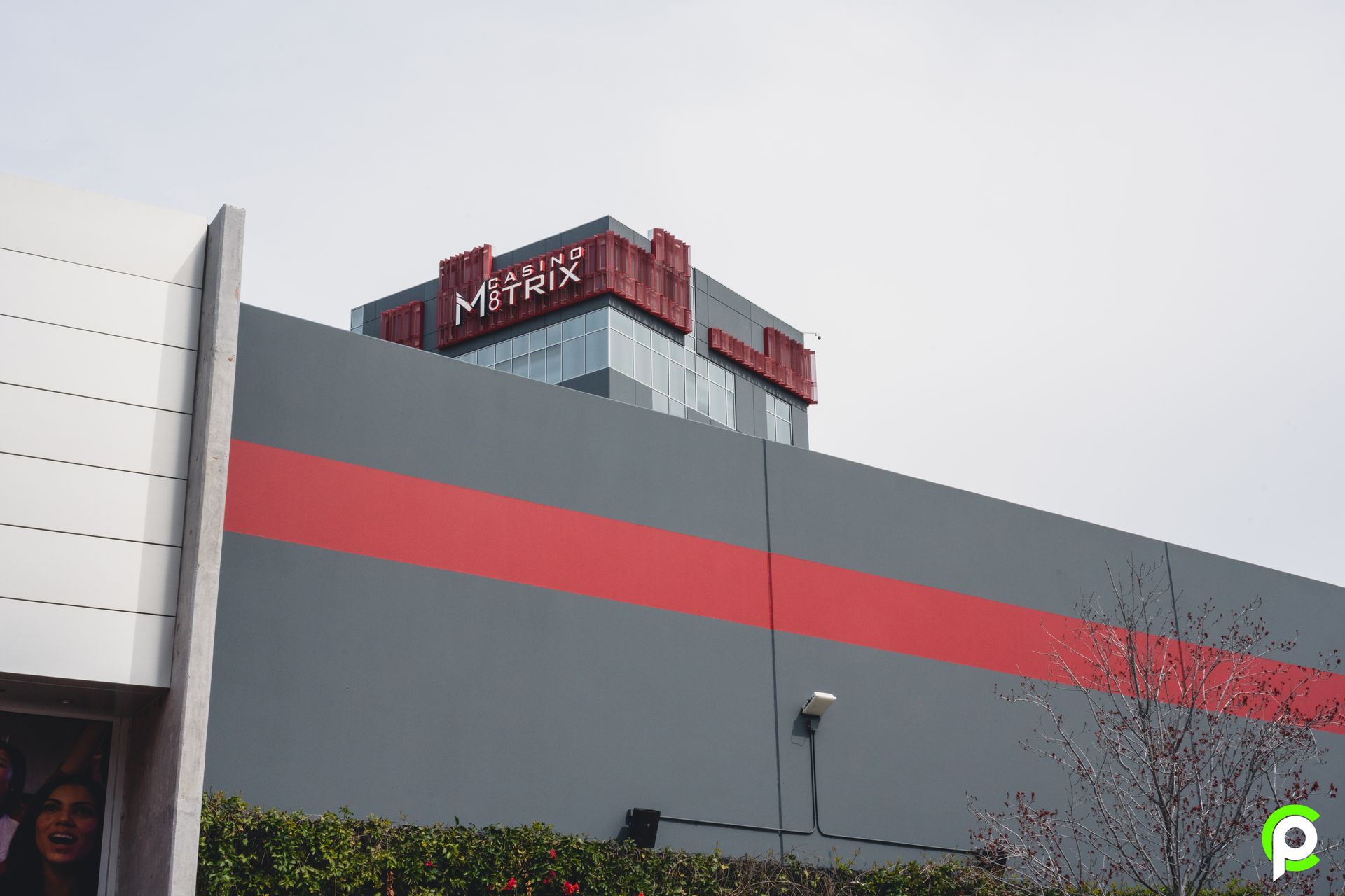 A large building with a red stripe on the side of it.