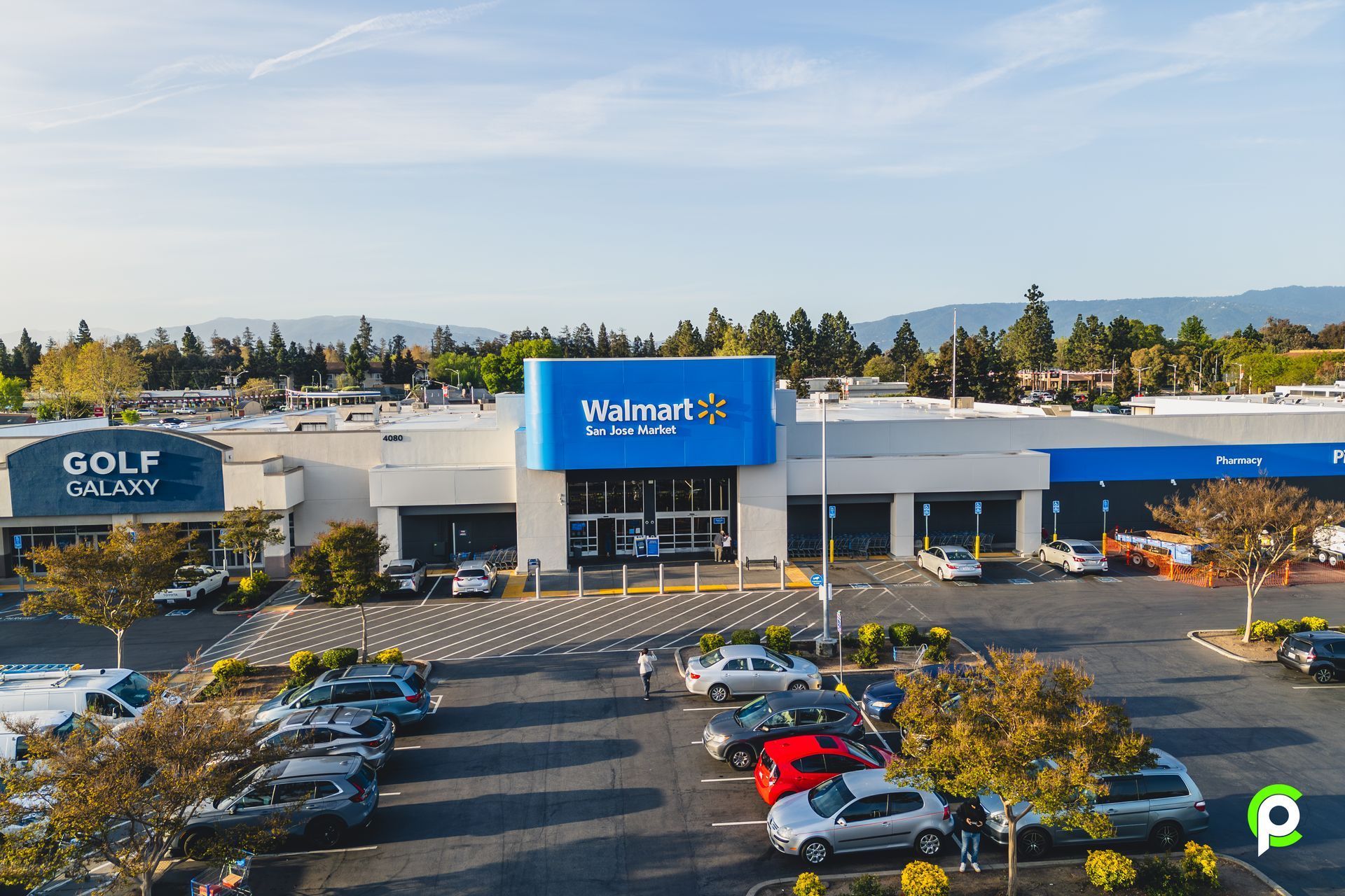 An aerial view of a walmart store with cars parked in front of it.