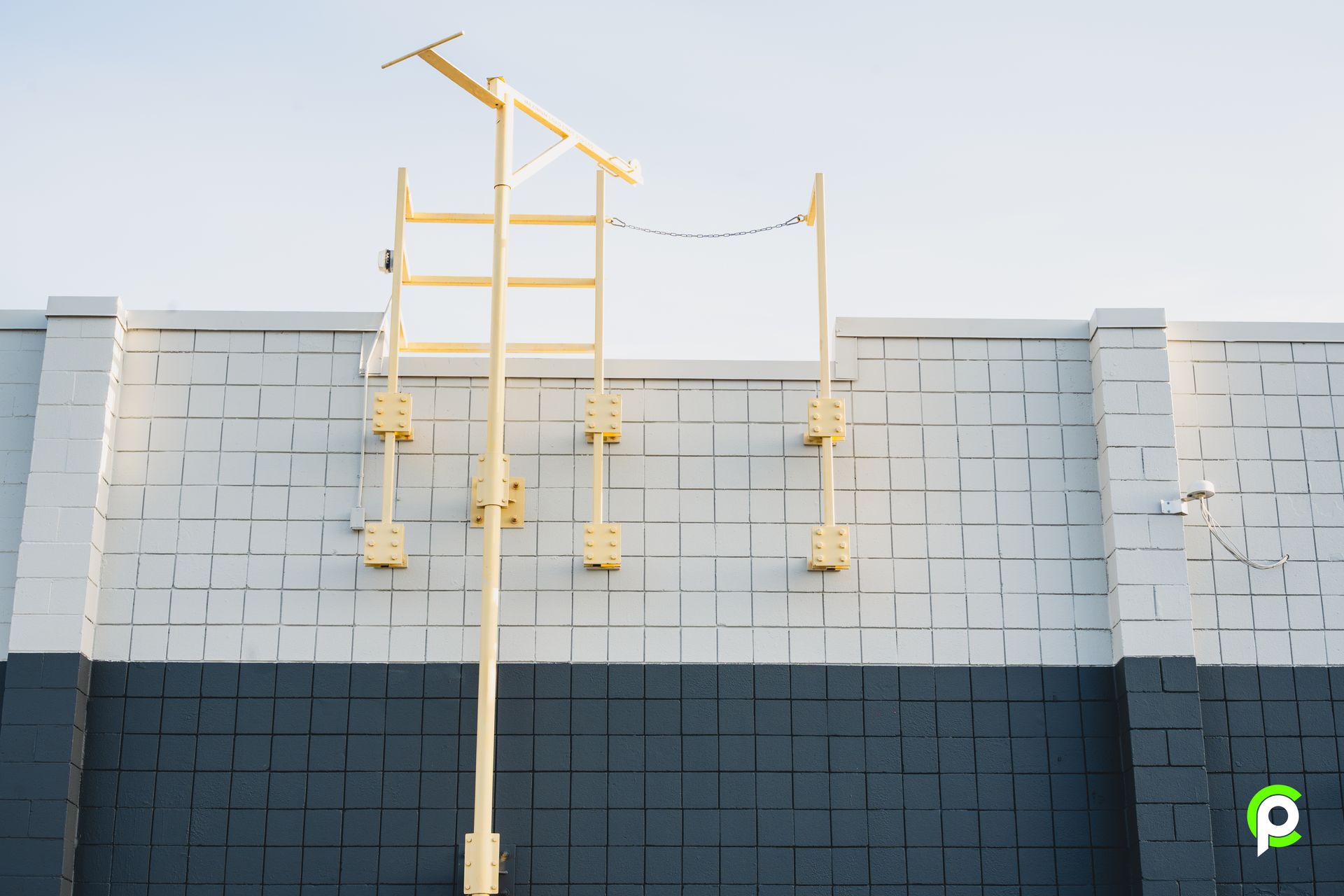 A yellow ladder is attached to the side of a building