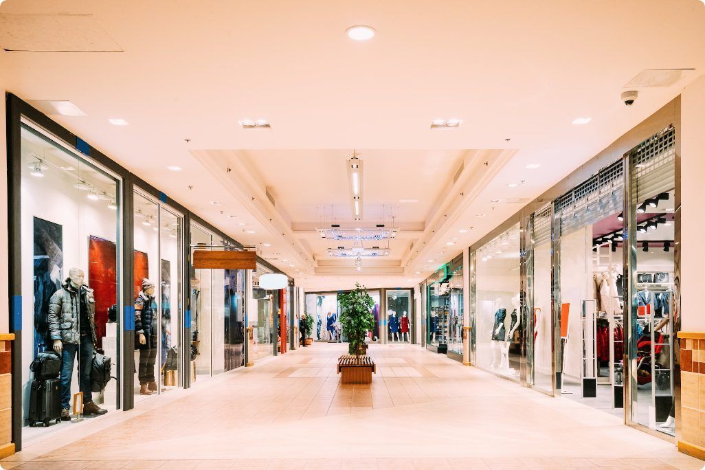 A blurred image of an empty shopping mall with lots of shops.