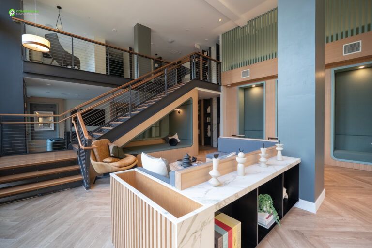 A living room with a staircase leading up to the second floor