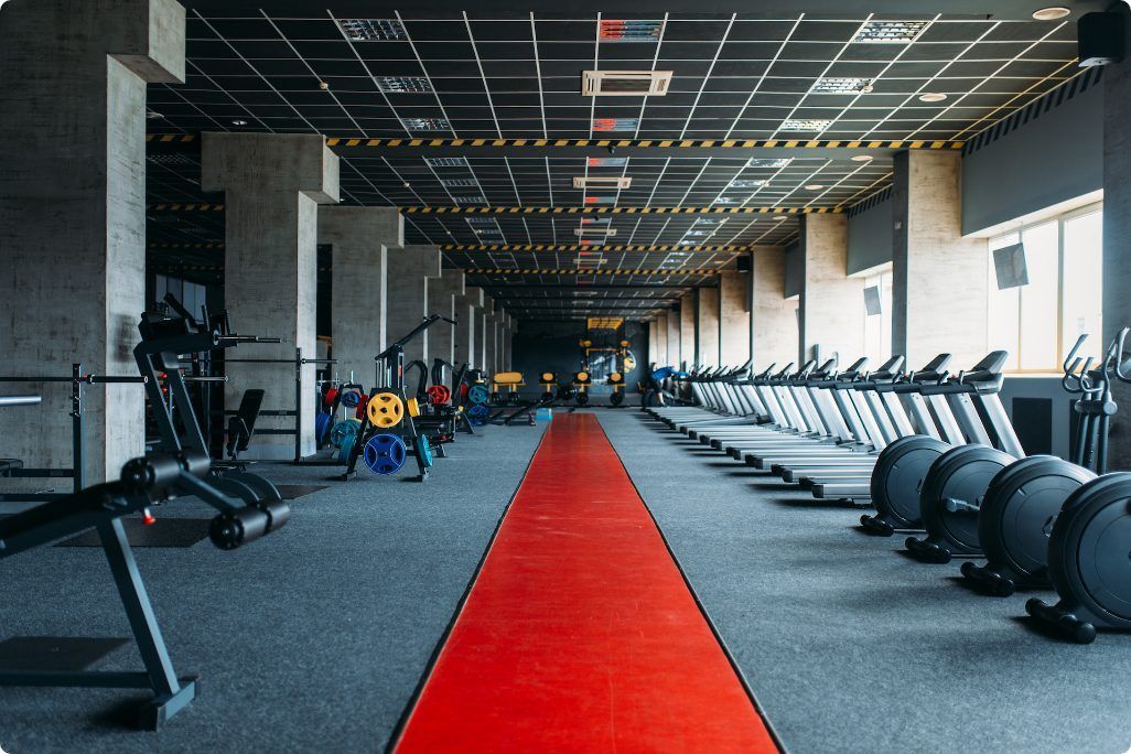 There is a red carpet in the middle of the gym.