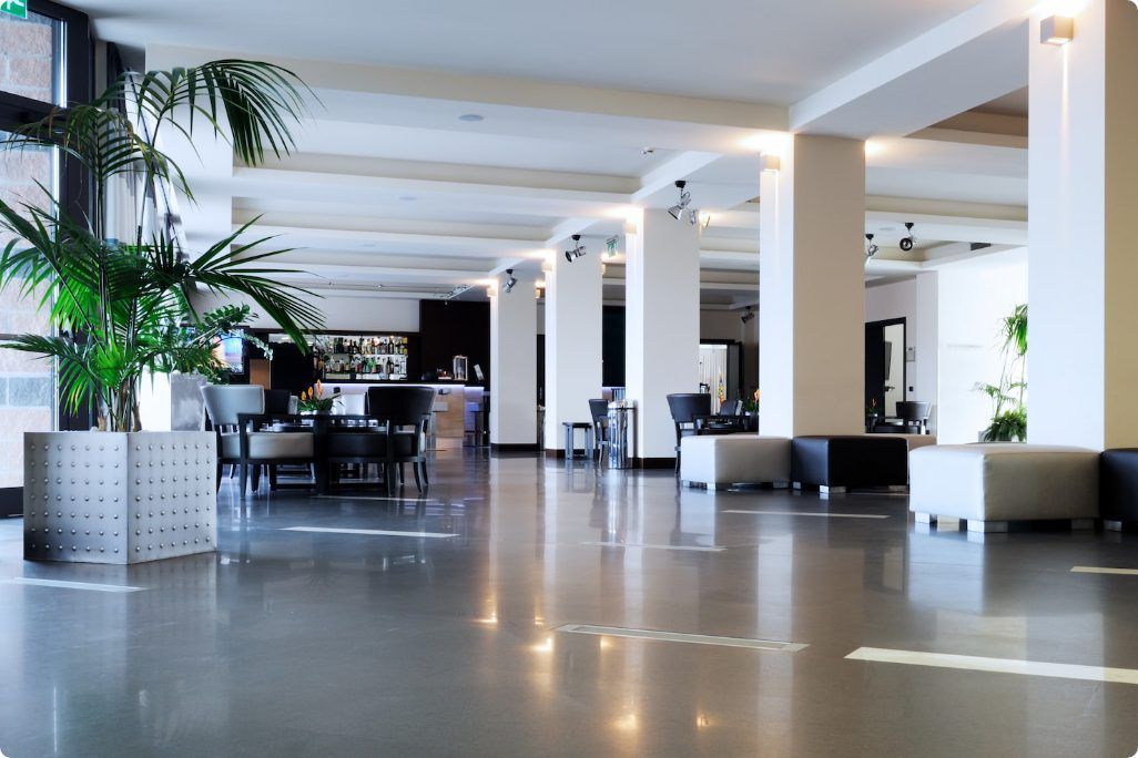 A hotel lobby with a lot of furniture and plants