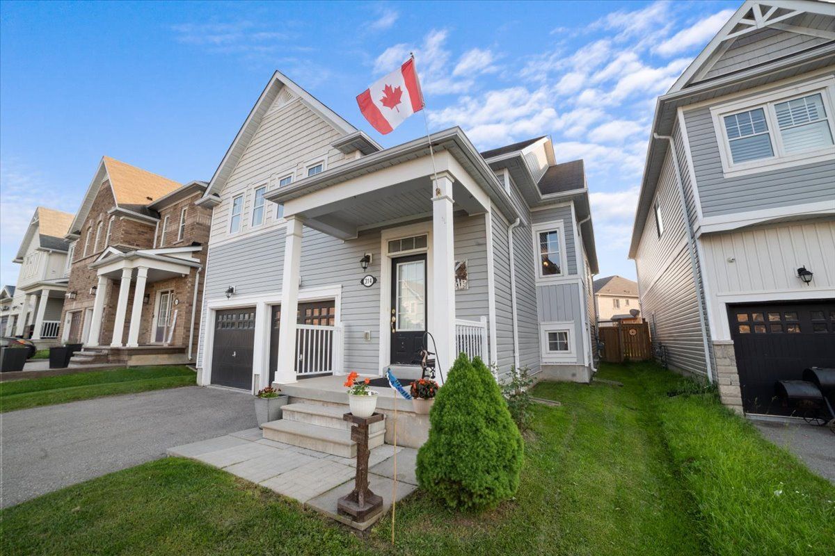A canadian flag is flying in front of a house.