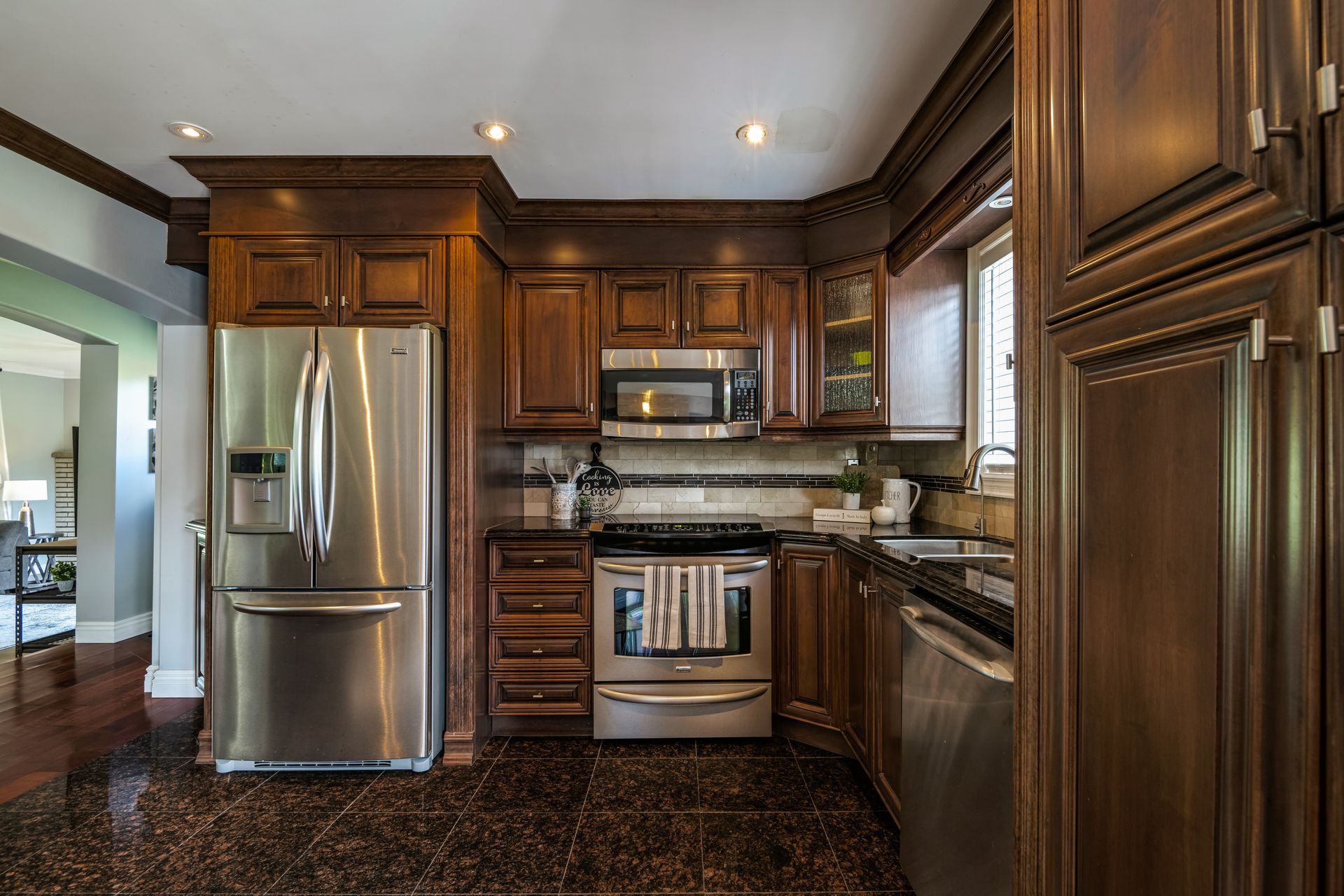 A kitchen with stainless steel appliances and wooden cabinets.