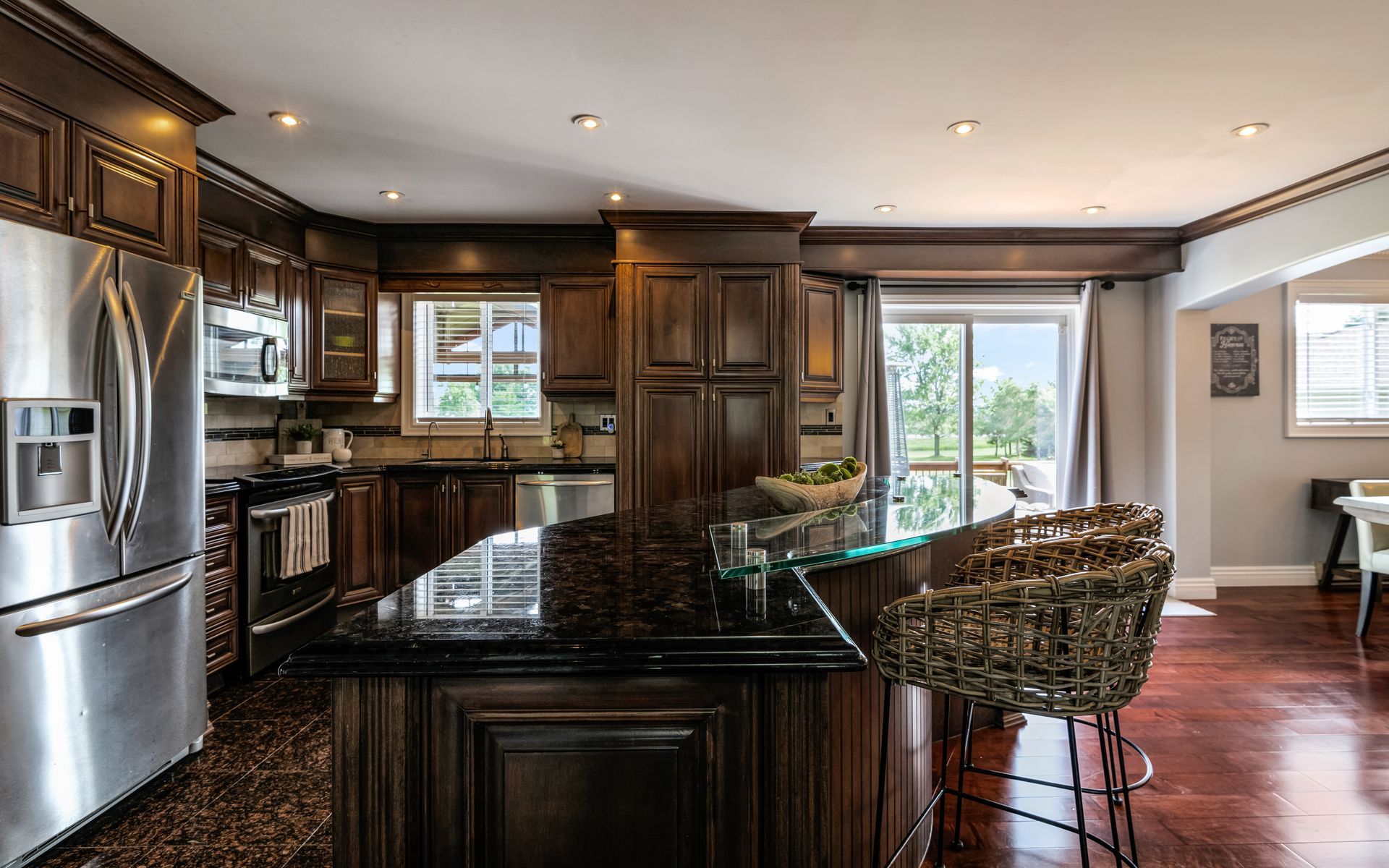 A kitchen with stainless steel appliances and a large island.