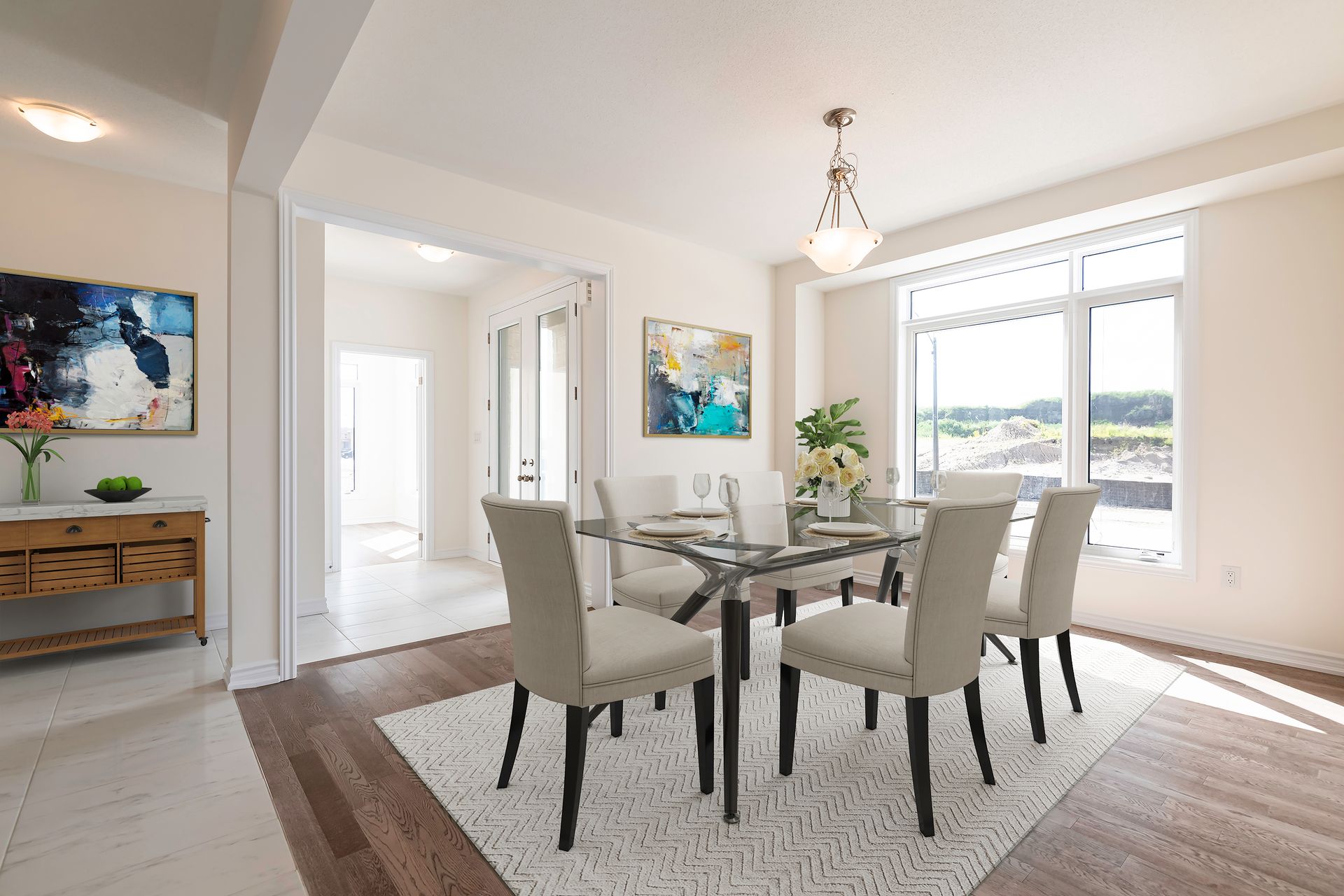 A dining room with a table and chairs and a rug.