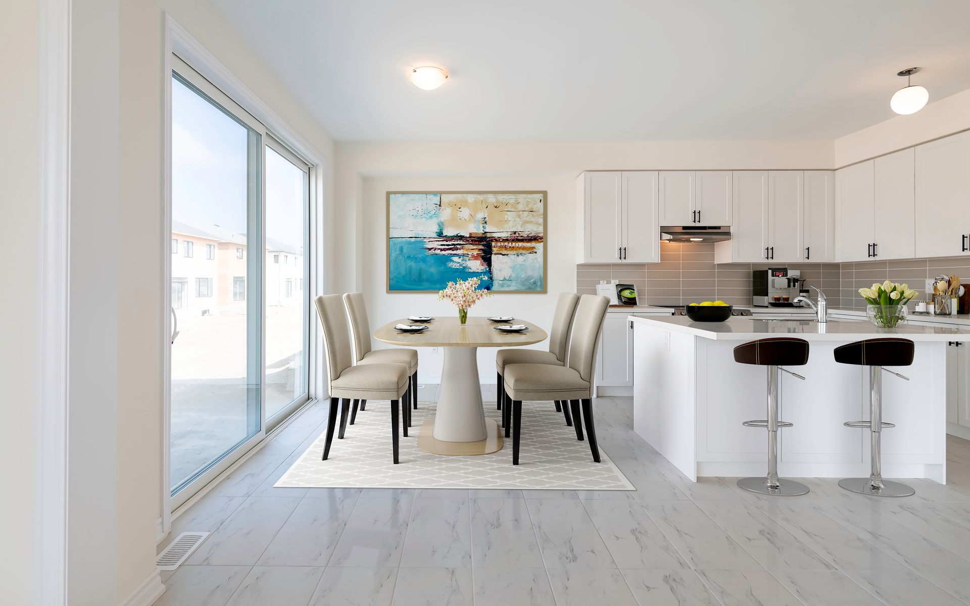 A kitchen and dining room in a house with a table and chairs