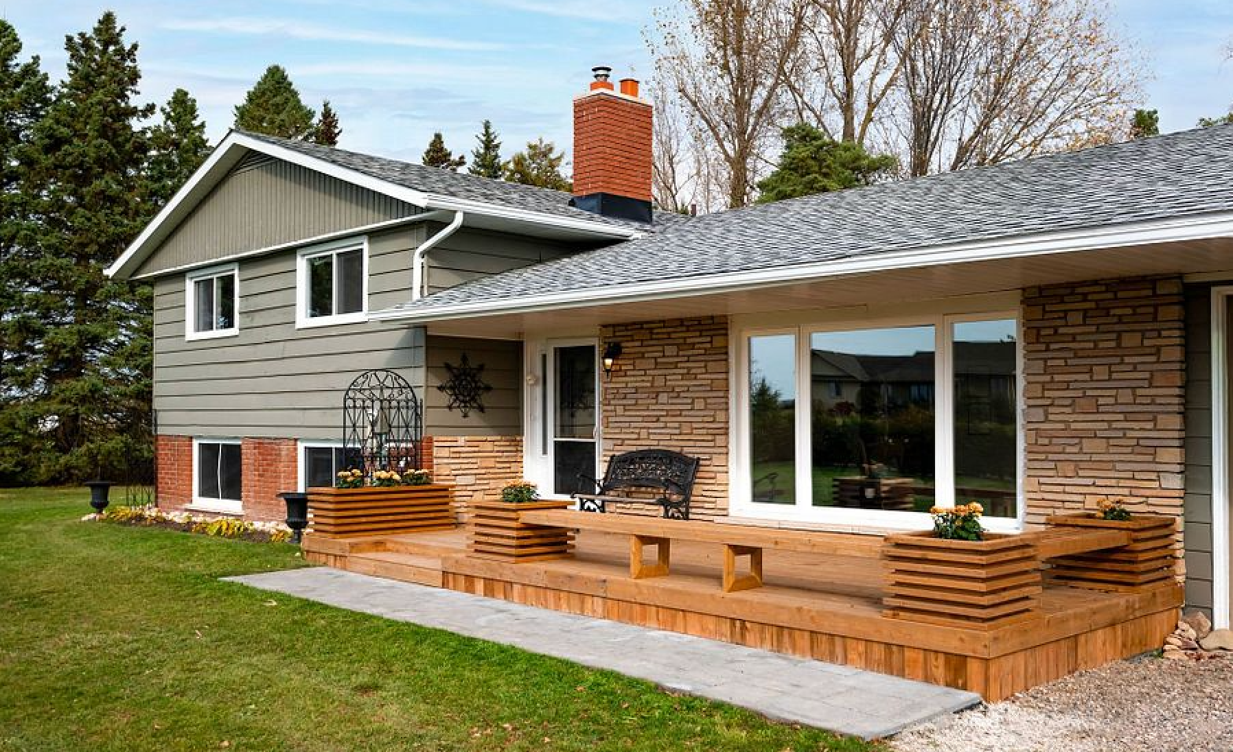 A large house with a large deck in front of it