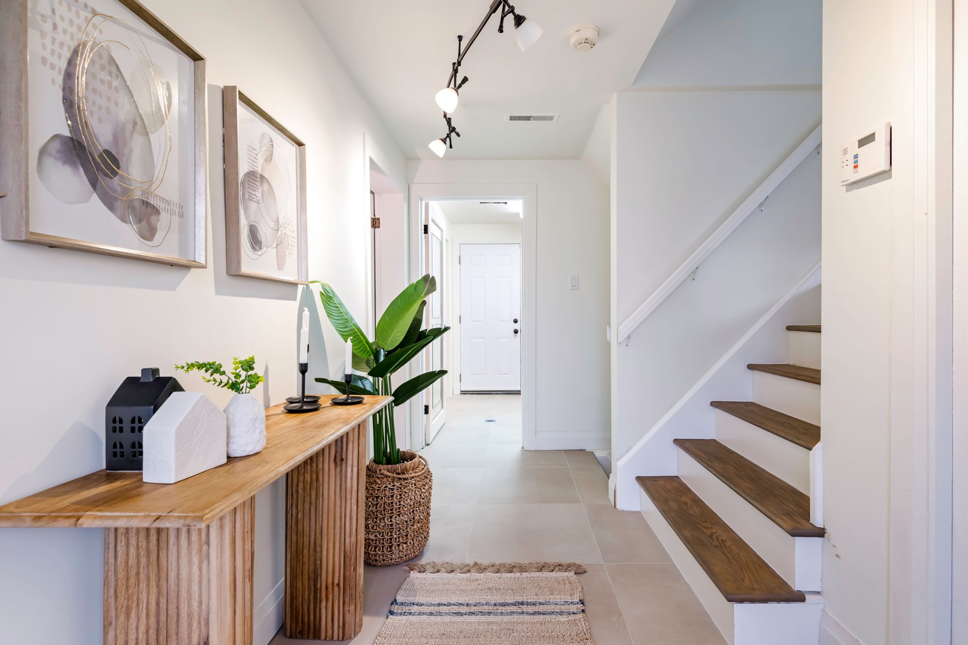 A hallway with stairs and a wooden table
