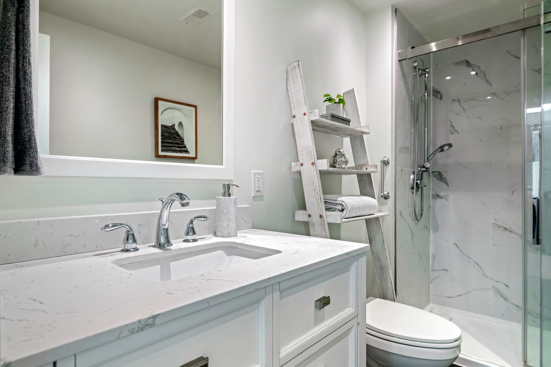 A bathroom with a sink , toilet and shower.