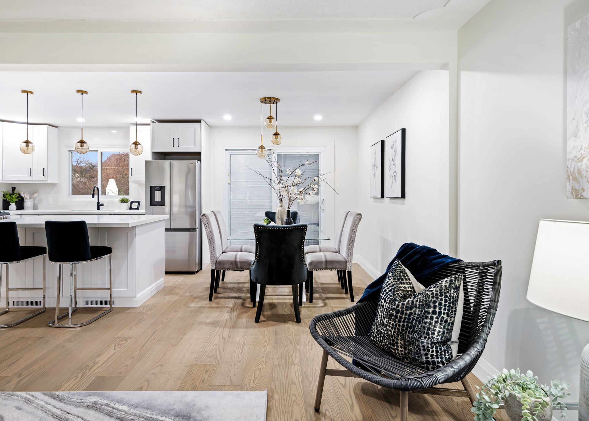 A living room , dining room , and kitchen in a house.