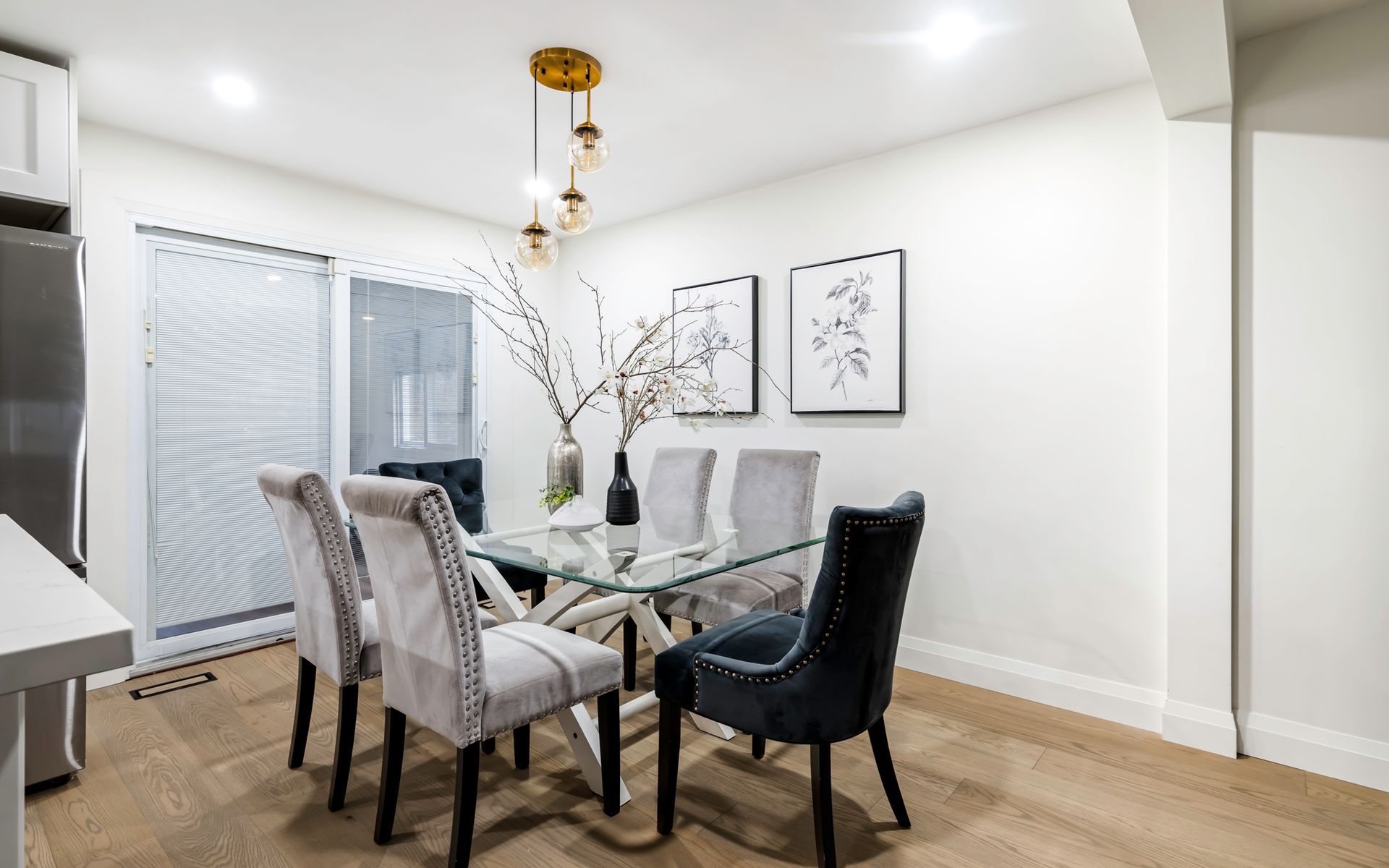 A dining room with a glass table and chairs.