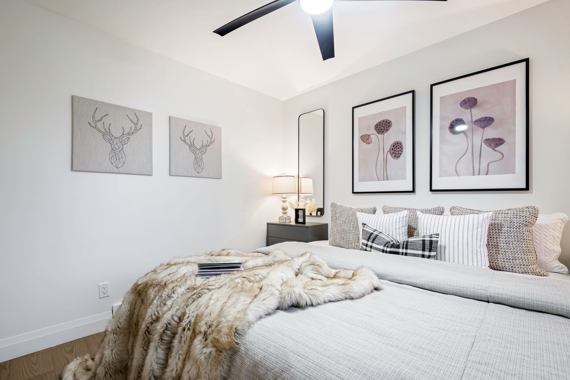 A bedroom with two beds and a ceiling fan.