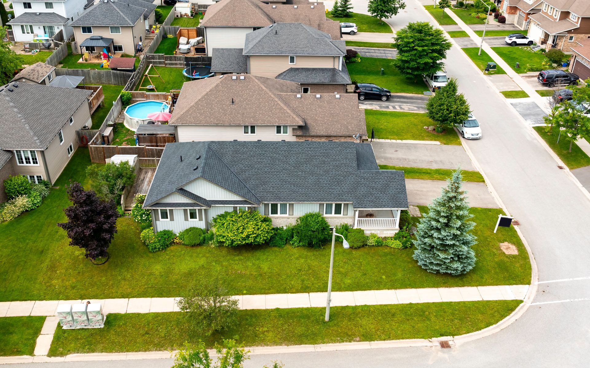 An aerial view of a house in a residential neighborhood