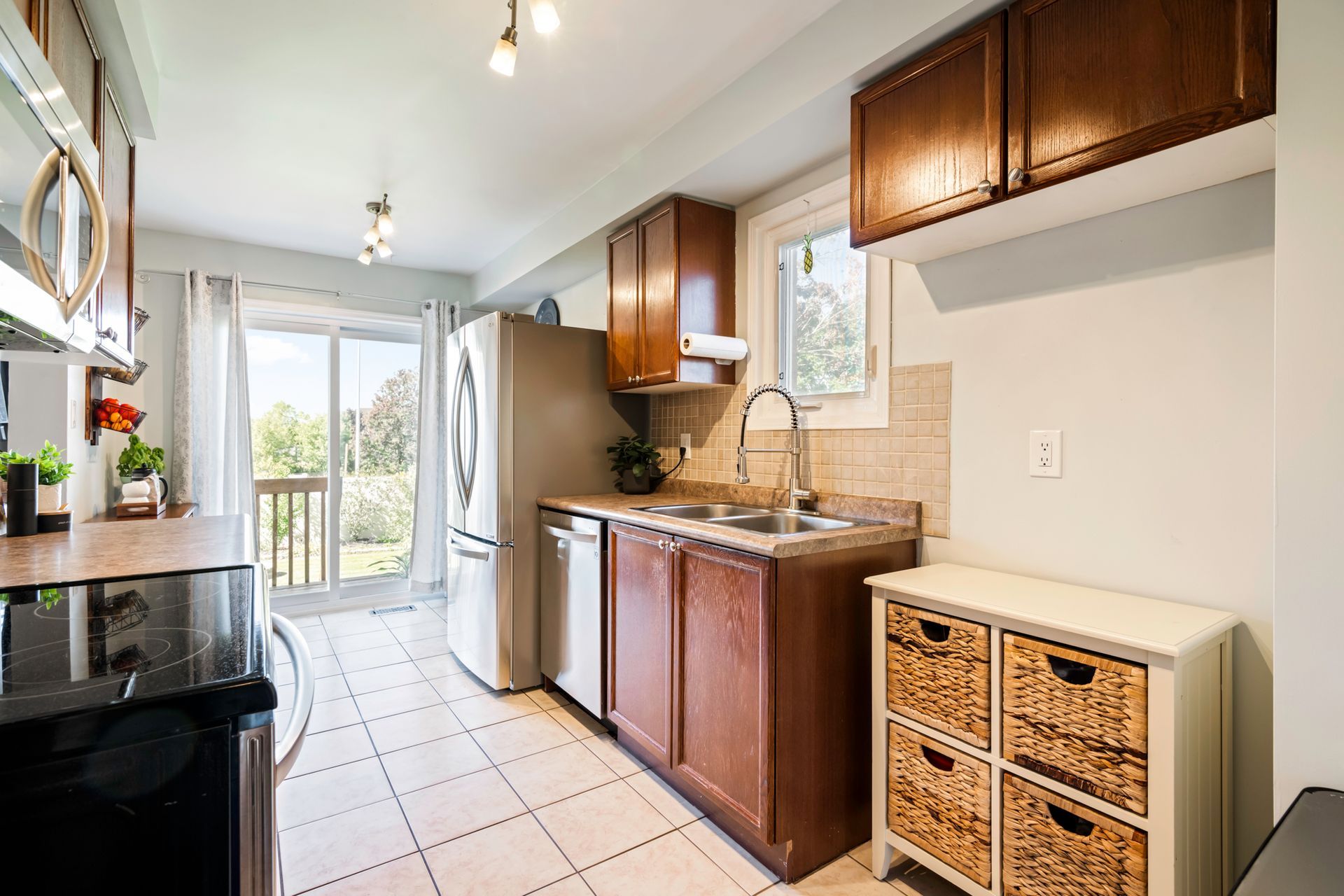 A kitchen with stainless steel appliances and wooden cabinets.