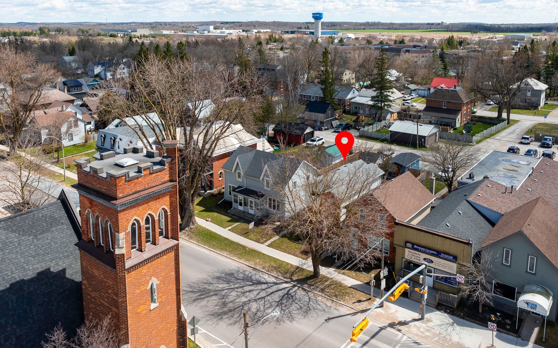 An aerial view of a small town with a water tower in the middle of it.